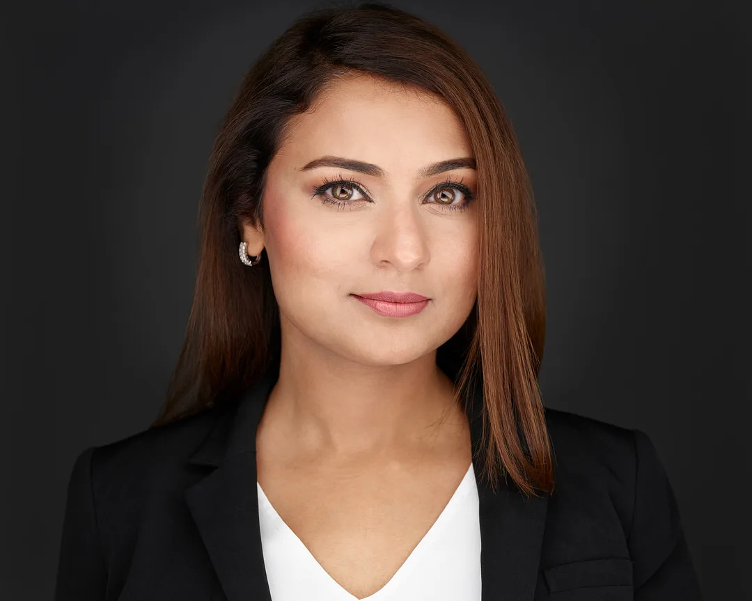 Professional headshot with dark background — NYC studio session